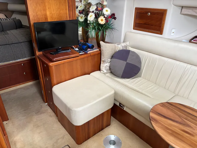 Slide: The Image of Luxurious interior of 2004 Riviera 4000 yacht with TV, seating, and floral decor. - 13