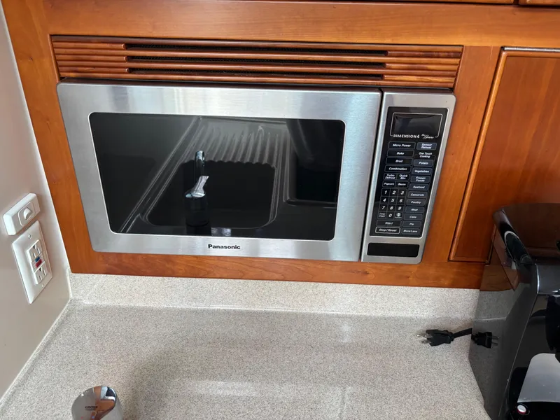 Slide: The Image of Built-in Panasonic microwave in a 2004 Riviera 4000 yacht kitchen. - 15