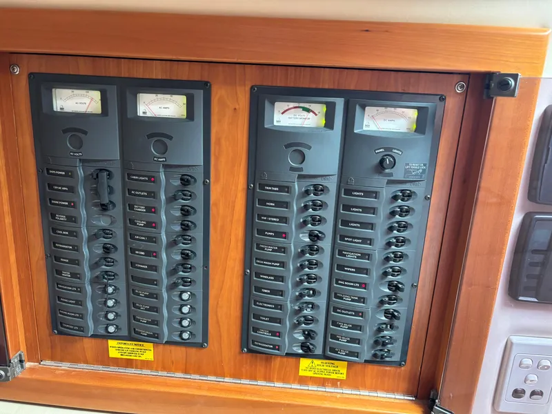 Slide: The Image of Electrical control panel on a 2004 Riviera 4000 boat, featuring switches and meters. - 17