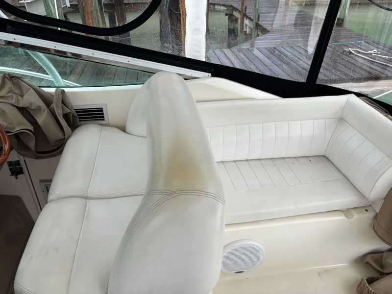 Slide: The Image of Interior seating of a 2004 Riviera 4000 boat with white upholstery. - 22