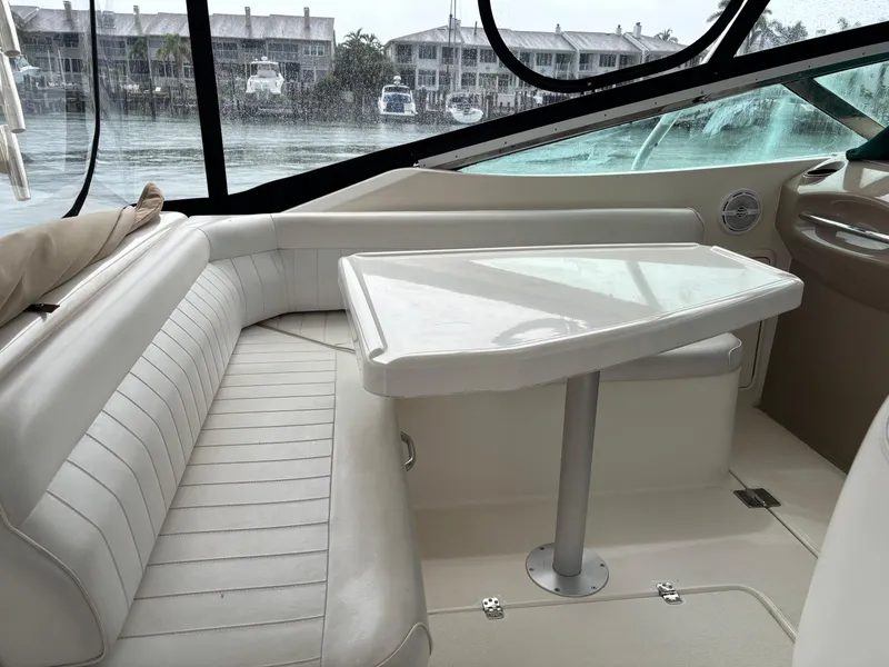 Slide: The Image of Interior of a 2004 Riviera 4000 yacht with white seating and table. - 23