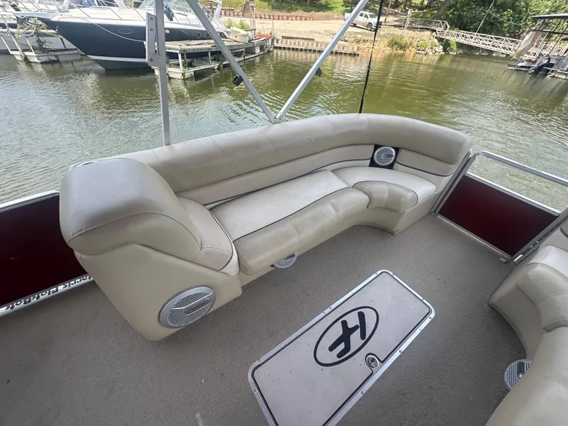 Slide: The Image of 2012 Harris FloteBote Grand Mariner SEL 250 interior with beige seating and lake view. - 14