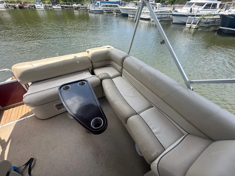 Slide: The Image of 2012 Harris FloteBote Grand Mariner SEL 250 interior with beige seating and cupholder table. - 17