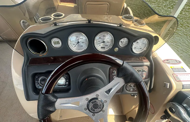 Slide: The Image of Steering console of 2012 Harris FloteBote Grand Mariner SEL 250 with gauges and controls. - 24