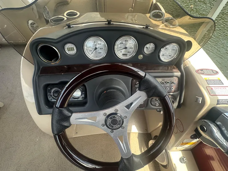 Slide: The Image of Steering console of 2012 Harris FloteBote Grand Mariner SEL 250 with gauges and controls. - 25