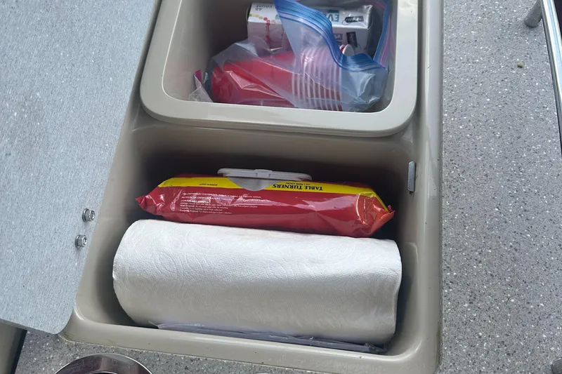 Slide: The Image of Storage compartment on a 2012 Harris FloteBote Grand Mariner SEL 250 with paper towels and supplies. - 32