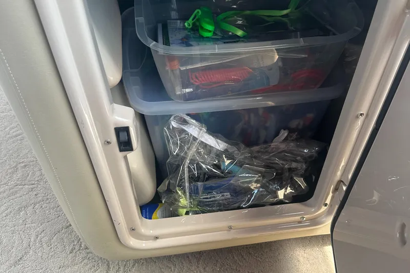 Slide: The Image of Storage compartment on a 2012 Harris FloteBote Grand Mariner SEL 250 with organized plastic bins. - 33