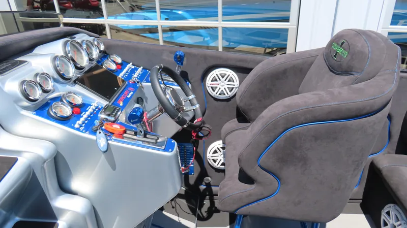 Slide: The Image of 2005 Cigarette 39' Top Gun Unlimited boat cockpit with gauges and plush seating. - 12