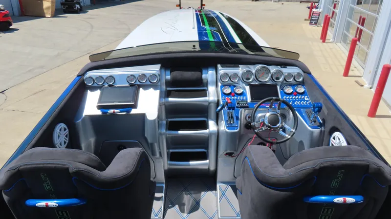 Slide: The Image of 2005 Cigarette 39' Top Gun Unlimited boat cockpit with advanced controls and dual seats. - 14