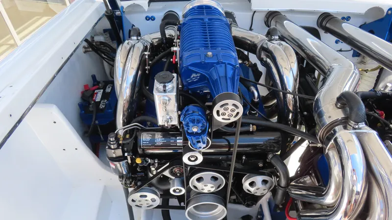 Slide: The Image of Engine of a 2005 Cigarette 39' Top Gun Unlimited boat, featuring chrome and blue components. - 17