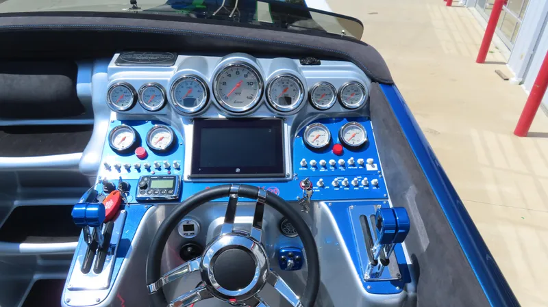 Slide: The Image of Dashboard of a 2005 Cigarette 39' Top Gun Unlimited boat with gauges and controls. - 18