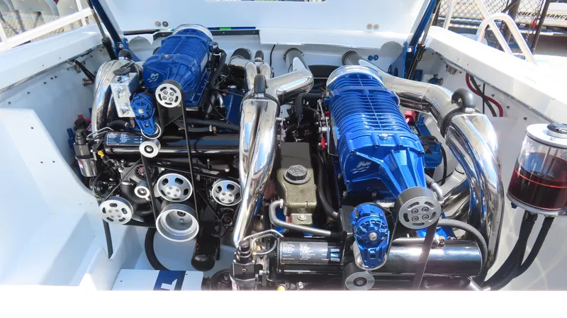 Slide: The Image of 2005 Cigarette 39' Top Gun Unlimited boat engine with blue and chrome components. - 21