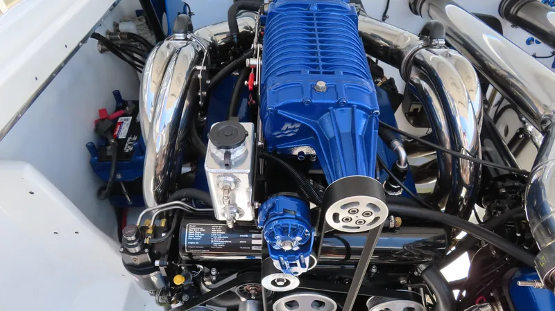 Slide: The Image of Engine of 2005 Cigarette 39' Top Gun Unlimited boat, featuring blue and chrome components. - 22
