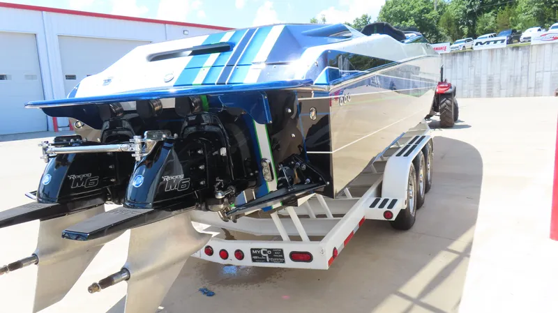Slide: The Image of 2005 Cigarette 39' Top Gun Unlimited boat on trailer, featuring dual Mercury Racing engines. - 5