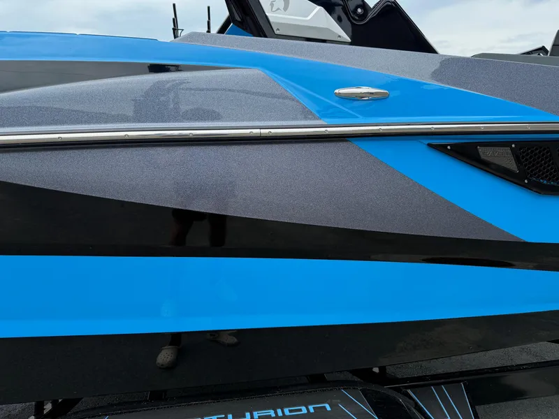 Slide: The Image of 2023 Centurion Fi23 boat with sleek blue and black design. - 13