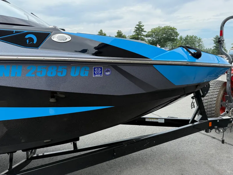 Slide: The Image of 2023 Centurion Fi23 boat on trailer, blue and black design, registration NH 2585 UG. - 15