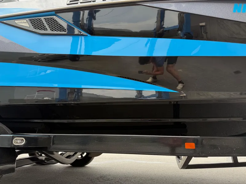 Slide: The Image of 2023 Centurion Fi23 boat with sleek black and blue design details. - 16