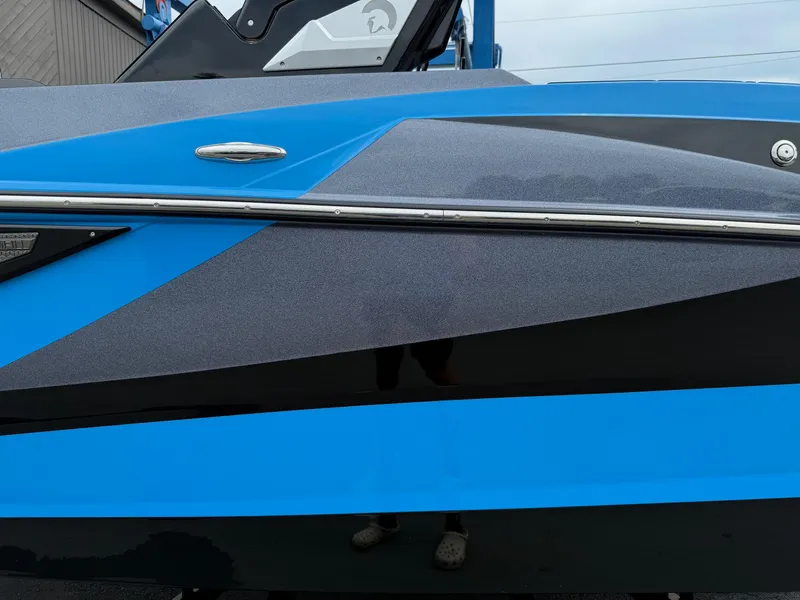 Slide: The Image of 2023 Centurion Fi23 boat with sleek blue and black design. - 8