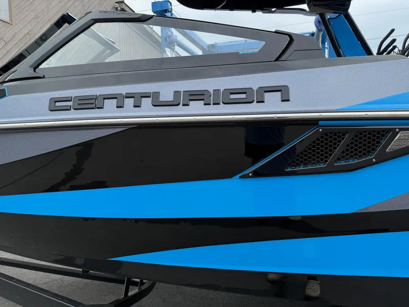 Slide: The Image of 2023 Centurion Fi23 boat with sleek blue and black design. - 9