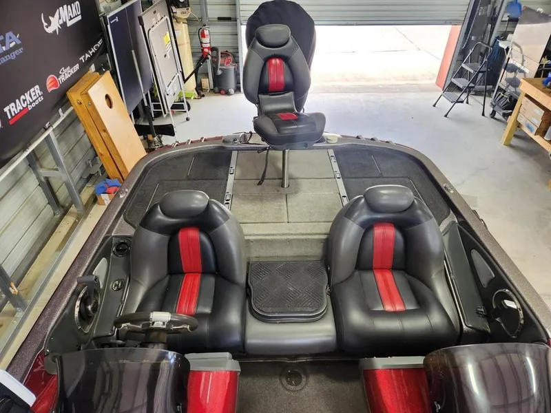 Slide: The Image of 2008 Ranger Z21 boat interior with black and red seats in a garage setting. - 9