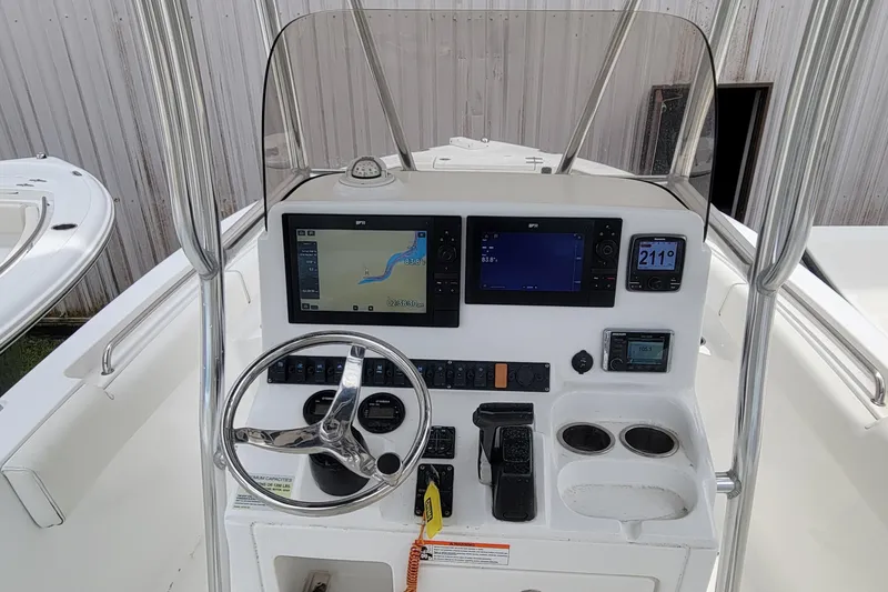 Slide: The Image of 2016 Sea Hunt Ultra 234 boat dashboard with navigation and control systems. - 3