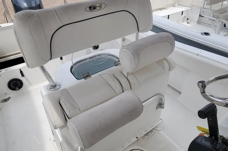 Slide: The Image of 2016 Sea Hunt Ultra 234 boat interior with cushioned seating and steering wheel. - 4