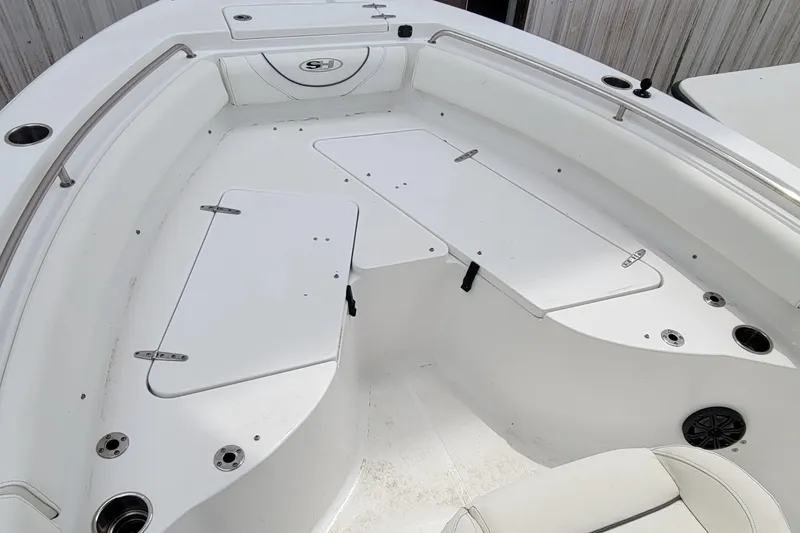Slide: The Image of 2016 Sea Hunt Ultra 234 boat interior with white seating and storage compartments. - 6