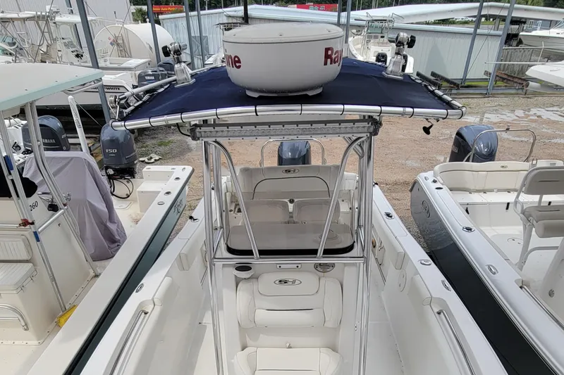 Slide: The Image of 2016 Sea Hunt Ultra 234 boat with T-top and Yamaha outboard motor in a marina. - 7