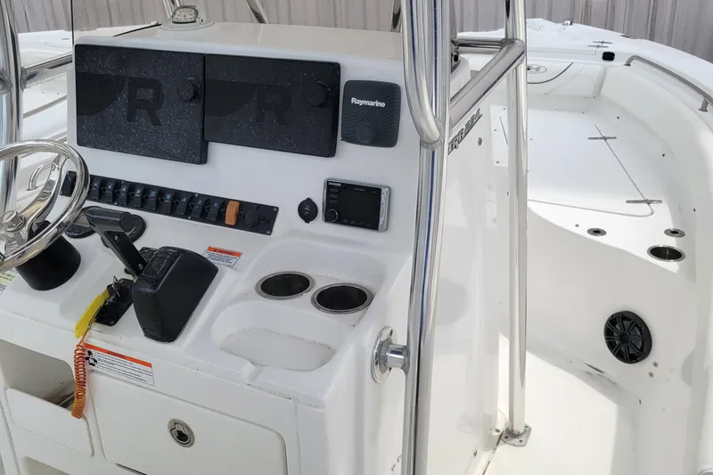 Slide: The Image of 2016 Sea Hunt Ultra 234 boat console with steering wheel and controls. - 8