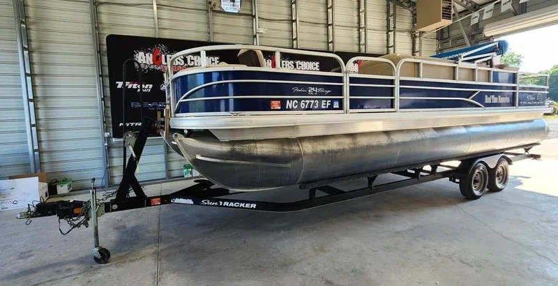 Slide: The Image of 2017 Sun Tracker FISHIN' BARGE® 24 DLX pontoon boat on trailer in garage. - 4