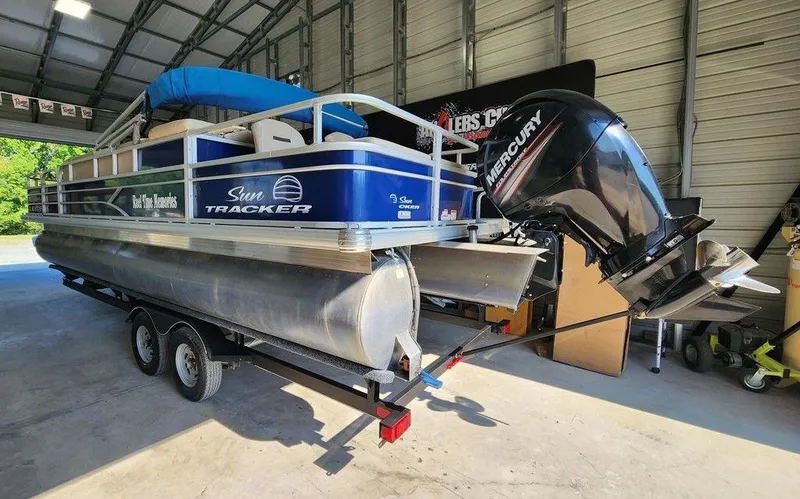 Slide: The Image of 2017 Sun Tracker FISHIN' BARGE® 24 DLX pontoon boat with Mercury engine in a garage. - 5