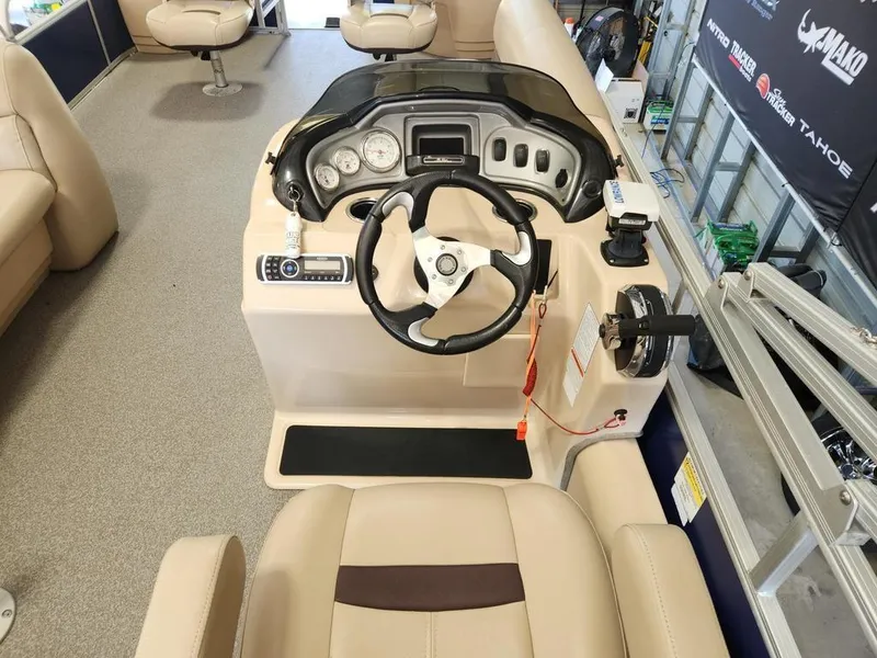 Slide: The Image of 2017 Sun Tracker FISHIN' BARGE® 24 DLX boat interior with steering console and seating. - 6