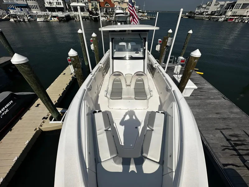 Slide: The Image of 2012 Everglades 295 Center Console boat docked at marina with waterfront view. - 11