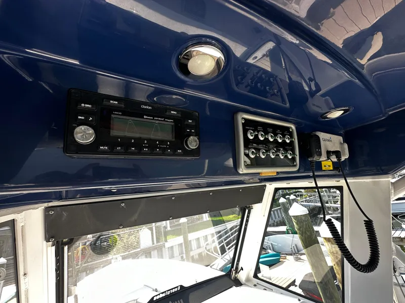 Slide: The Image of Interior of 2012 Everglades 295 Center Console with control panel and marine electronics. - 16