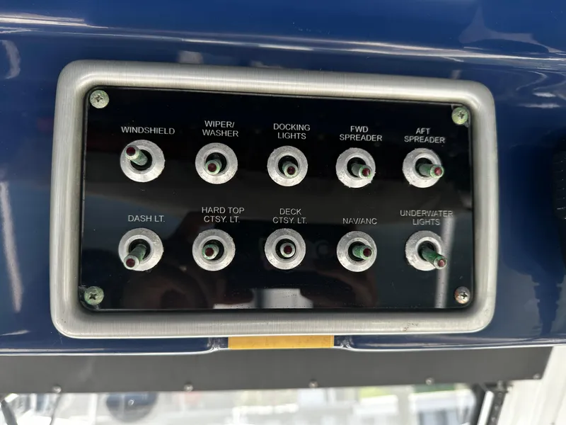 Slide: The Image of Control panel of a 2012 Everglades 295 Center Console boat with labeled switches. - 17