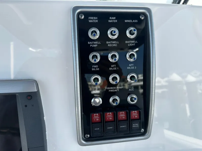 Slide: The Image of Control panel of a 2012 Everglades 295 Center Console boat with various switches. - 18