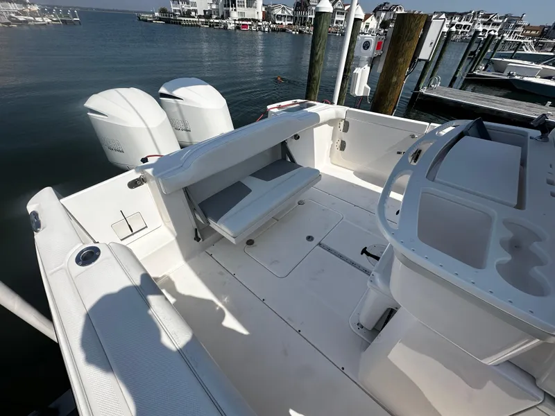 Slide: The Image of 2012 Everglades 295 Center Console boat docked, featuring spacious deck and dual engines. - 20