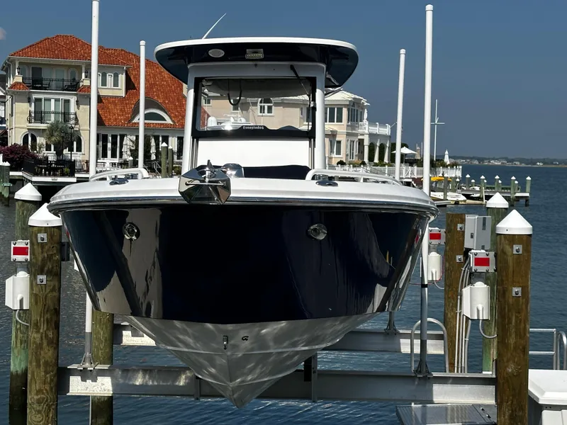 Slide: The Image of 2012 Everglades 295 Center Console boat docked near waterfront homes. - 23