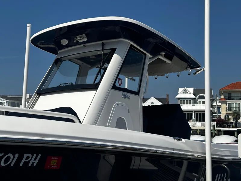 Slide: The Image of 2012 Everglades 295 Center Console boat docked near waterfront homes. - 3