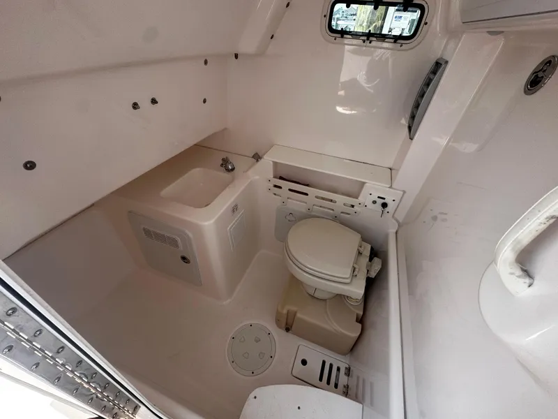 Slide: The Image of Interior of 2012 Everglades 295 Center Console boat with toilet and sink. - 9