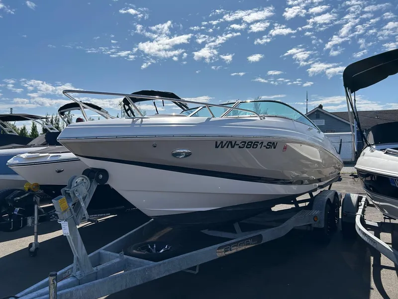 Slide: The Image of 2016 Regal 2250 Cuddy boat on trailer under a clear blue sky. - 11