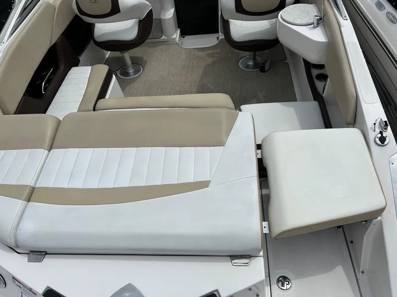 Slide: The Image of 2016 Regal 2250 Cuddy boat interior with beige and white seating arrangement. - 12