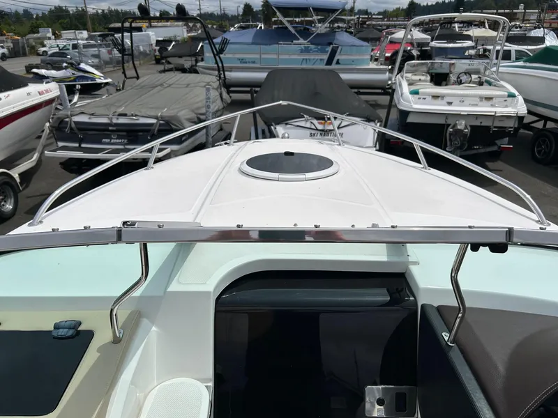 Slide: The Image of 2016 Regal 2250 Cuddy boat, docked among other boats, viewed from the bow. - 15