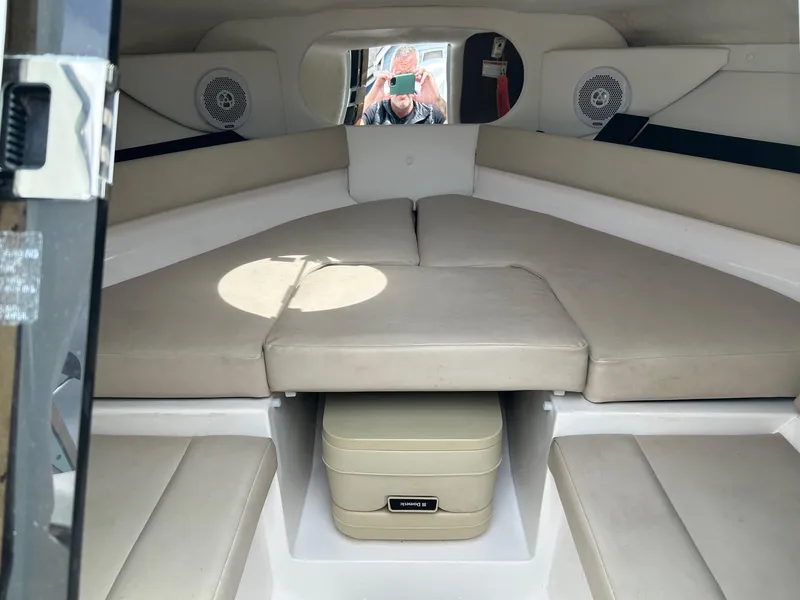 Slide: The Image of 2016 Regal 2250 Cuddy cabin interior with beige seating and storage compartment. - 18