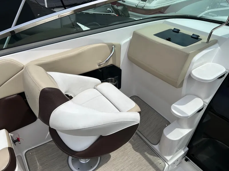 Slide: The Image of 2016 Regal 2250 Cuddy boat interior with beige and brown seating. - 22