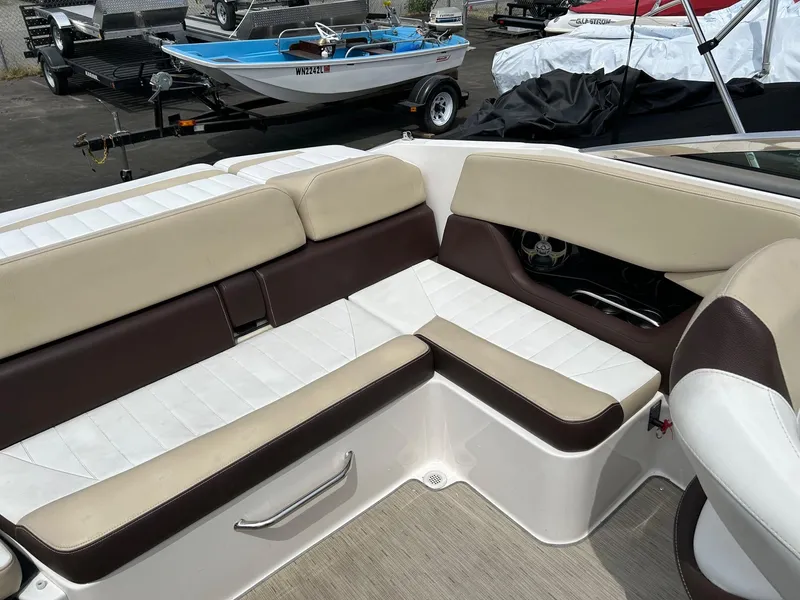 Slide: The Image of 2016 Regal 2250 Cuddy boat interior with beige and brown seating. - 23