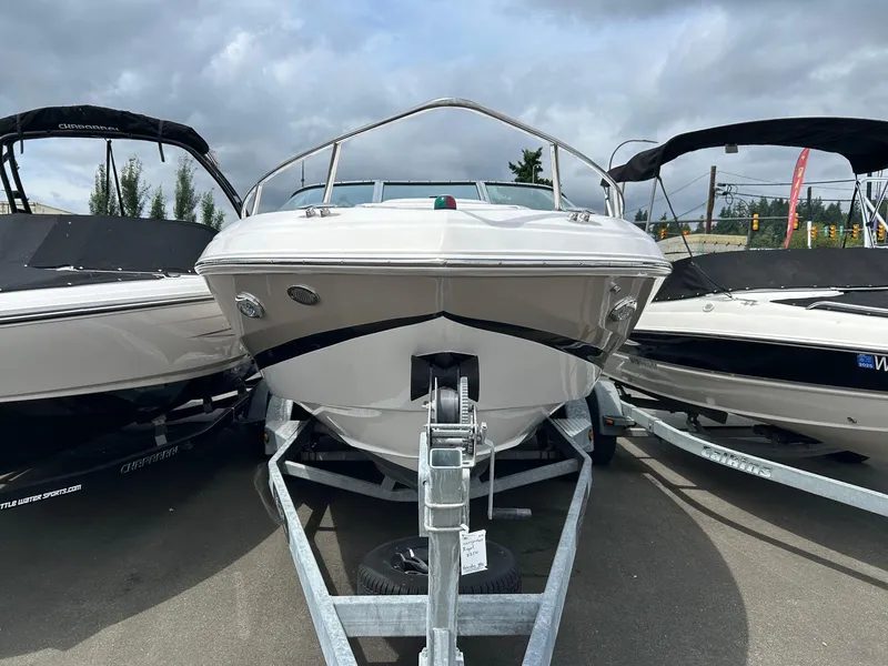 Slide: The Image of 2016 Regal 2250 Cuddy boat on trailer, parked outdoors under cloudy sky. - 3