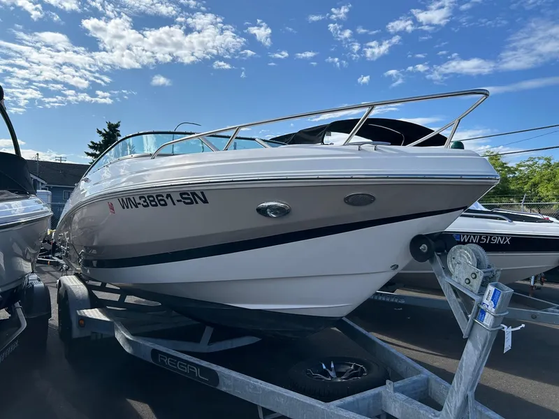 Slide: The Image of 2016 Regal 2250 Cuddy boat on trailer under a clear blue sky. - 4