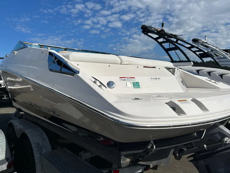 Slide: The Image of 2016 Regal 2250 Cuddy boat on trailer under a blue sky. - 5