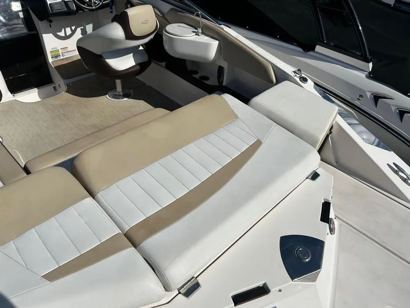 Slide: The Image of 2016 Regal 2250 Cuddy boat interior with beige and white seating. - 6